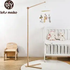 Baby wooden rattle mobile with floor stand bracket hanging over white crib